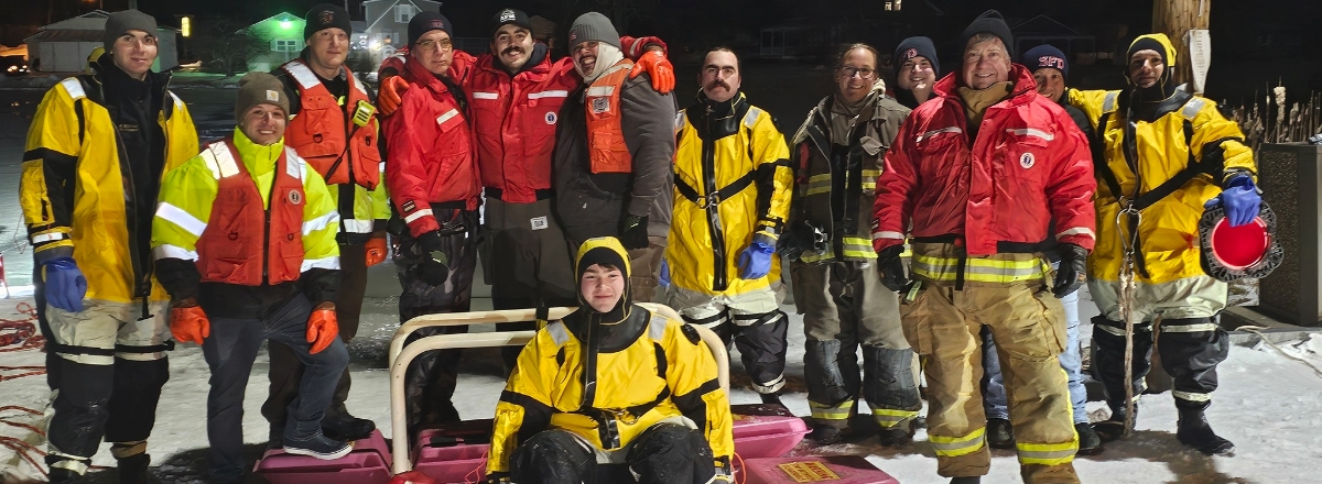 first responders in wet gear after rescue at night